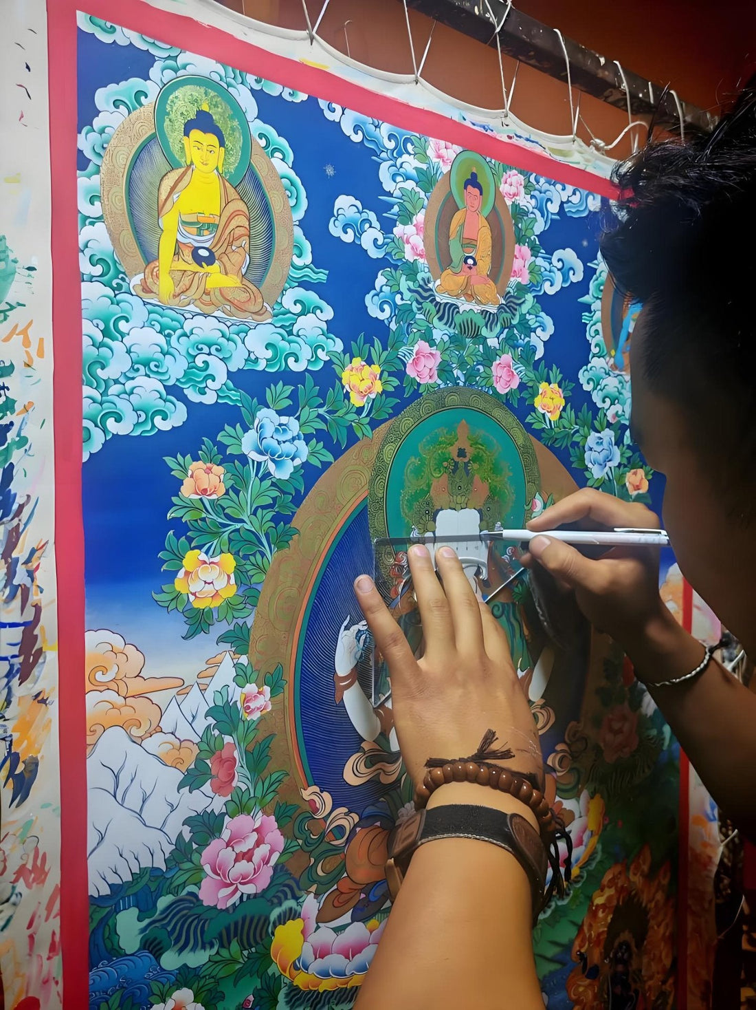 A contemporary painter grinding mineral pigments for a hand-painted thangka