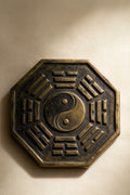 Bagua octagonal trigram emblem in aged bronze relief around a yin-yang center
